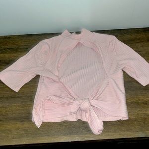 Pink open back cropped tee.